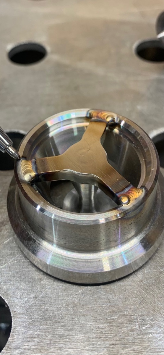 Two machined parts welded together inside a stainless housing